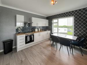 a kitchen with a table and chairs in a room at Poplar Zareba in Anderby