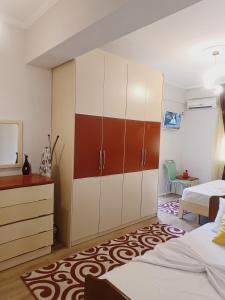 a bedroom with two beds and a cabinet at Arthouse Elbasan in Elbasan