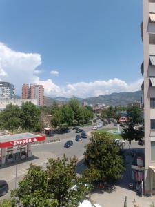 a city street with cars parked in a parking lot at Arthouse Elbasan in Elbasan