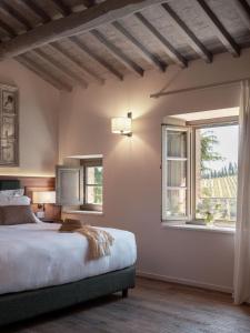 a bedroom with a bed and a window at Tenuta Bartoli in San Gimignano