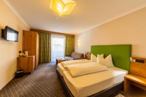 a hotel room with a bed and a couch at Hotel Mozart in Landeck +29 photos