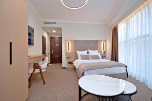 a hotel room with two beds and a desk at BM Avenue Hotel in Yerevan +72 photos