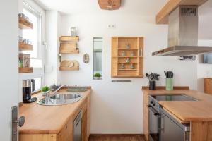a kitchen with a sink and a counter at Apartment Lichterfunkeln für junge Paare mit Panorama-Seeblick in Daisendorf