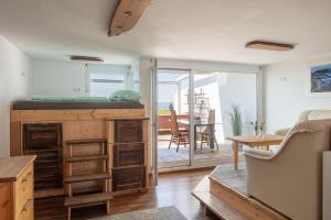a living room with a bed on top of a desk at Apartment Lichterfunkeln für junge Paare mit Panorama-Seeblick in Daisendorf