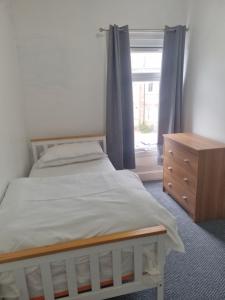 a bedroom with a bed and a dresser and a window at City view place, City Centre in Chesterton
