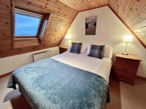 a bedroom with a large bed in a cabin at Fern Cottage - Uk5868 in Achmelvich