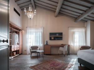 a bedroom with a bed and a desk and chairs at Tenuta Bartoli in San Gimignano