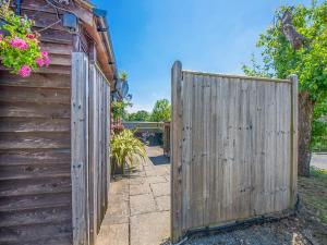 a wooden fence in front of a house at The Lodge in Northiam