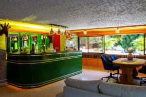 a bar in a restaurant with a table and chairs at Casa Elixir Boutique in Barranquilla