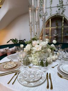 a table with plates and glasses on top of it at Casa Elixir Boutique in Barranquilla