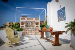 a patio with a table and chairs and a building at Casa Elixir Boutique in Barranquilla