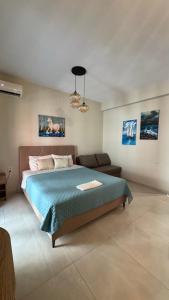 a bedroom with a large bed and a couch at J&B Suites in Kavála