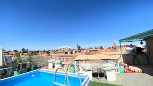 a swimming pool on the roof of a house at Riad Makech in Marrakesh