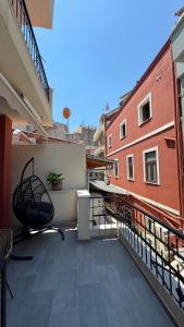 a balcony with a chair on top of a building at J&B Suites in Kavála