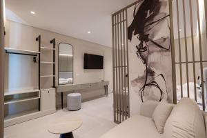 a living room with a couch and a tv at Marea Suites Borsh in Borsh +141 photos