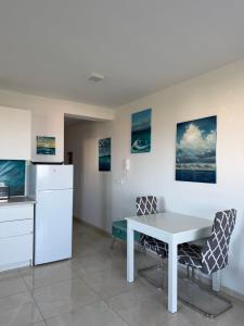 a kitchen with a white table and chairs at Apartment „Blue“ in Mandre +12 photos