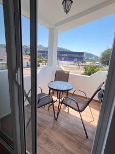 a table and chairs on a balcony with a view at Apartman Jana in Bar
