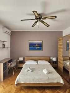 a bedroom with a bed and a ceiling fan at Rooms Perina Tisno in Tisno