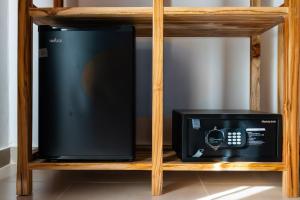 a television and a microwave on a shelf at African Bungalows in Nungwi +122 photos