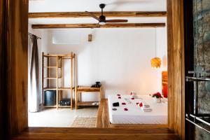 a bedroom with a bed and a ceiling fan at African Bungalows in Nungwi
