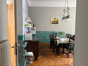 a kitchen and dining room with a table and chairs at GREEN HOUSE Hostel in Krakow