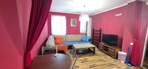 a living room with a couch and a tv at Old town Budva D&M in Budva