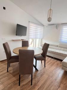 a living room with a table and chairs and a couch at Apartman Jana in Bar
