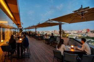 a group of people sitting at tables on a patio at ADAY Hotel Casablanca in Casablanca