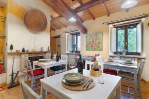 a dining room with a table and chairs and a fireplace at Nerbone Farm Retreat in Perugia