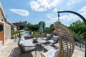 a patio with chairs and a swing at LA MARLENA in Benkovac