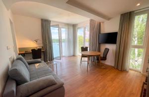 a living room with a couch and a table at H24 Hotel Berlin Grünau in Berlin