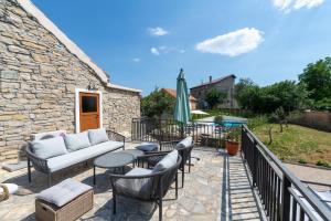 a patio with a couch and tables and chairs at LA MARLENA in Benkovac