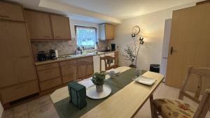 a kitchen with a wooden table and a table sidx sidx sidx at Gästehaus Zoller - Rettenberg im Allgäu in Rettenberg
