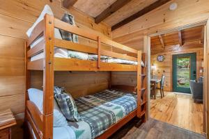 a bedroom with two bunk beds in a cabin at Tennessee Whisper Cabin in Sevierville