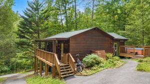 a cabin in the woods with a staircase leading to it at Tennessee Whisper Cabin in Sevierville