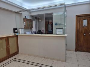 an empty office with a counter and a glass door at Hostal La Mexicana in Santander