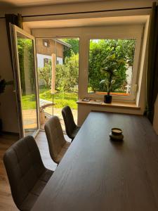 a dining room with a table and chairs and a window at Moderne große Wohnung mit Garten in Hausham