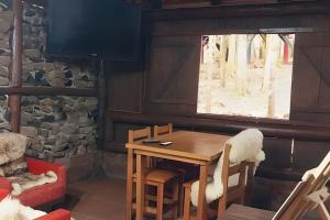 a wooden table and chairs in a room with a window at Cabana Bem-te-vi in Três Coroas