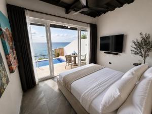 a bedroom with a bed and a view of the ocean at Epic Suites Bohol ADULTS ONLY in Dauis