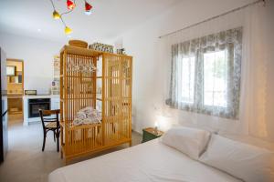 a bedroom with a bed and a table and a window at Topos Patela in Kalithies