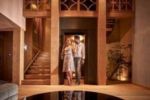 a man and a woman standing in front of a staircase at Domus Renier Boutique Hotel in Chania