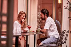 a man and a woman sitting at a table at Domus Renier Boutique Hotel in Chania