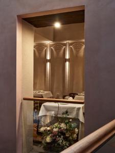 a mirror in a restaurant with a table with flowers at Domus Renier Boutique Hotel in Chania