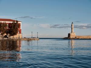 a lighthouse on a small island in the water at Domus Renier Boutique Hotel in Chania +123 photos