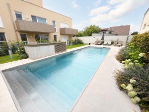 a swimming pool in the backyard of a house at Am See 18 in Podersdorf am See