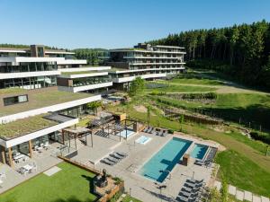 an aerial view of a building with a swimming pool at Anatura Hotel Luxembourg in Weiswampach