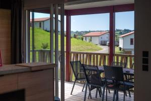 a patio with chairs and a table on a balcony at Chalet Etxean in Hasparren