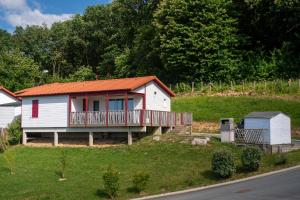 a small white house with an orange roof at Chalet Etxean in Hasparren