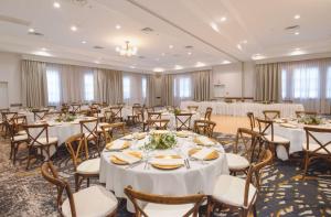 a banquet hall with white tables and chairs at Coast Canmore Hotel & Conference Centre in Canmore +31 photos
