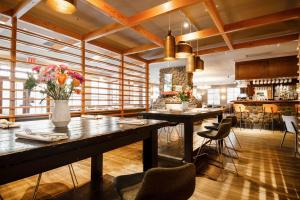 a restaurant with tables and chairs in a room at Coast Canmore Hotel & Conference Centre in Canmore